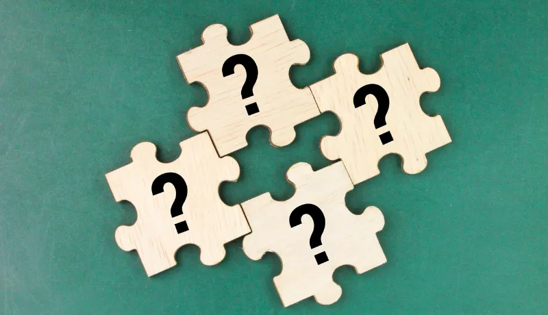 wooden puzzle with a question mark symbol. Concept of question,