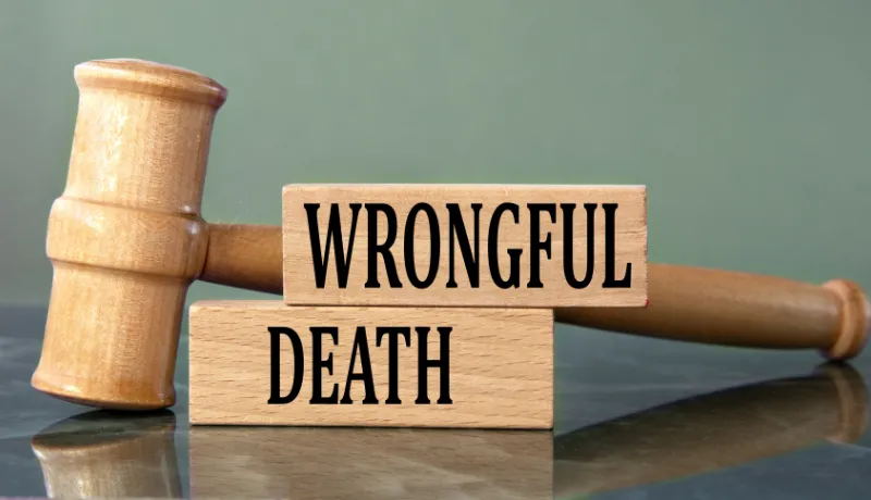 WRONGFUL DEATH - words on wooden blocks with a judge's gavel in the background