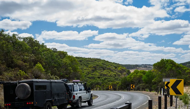 Four wheel drive truck towing a caravan on the scenic coastal drive,