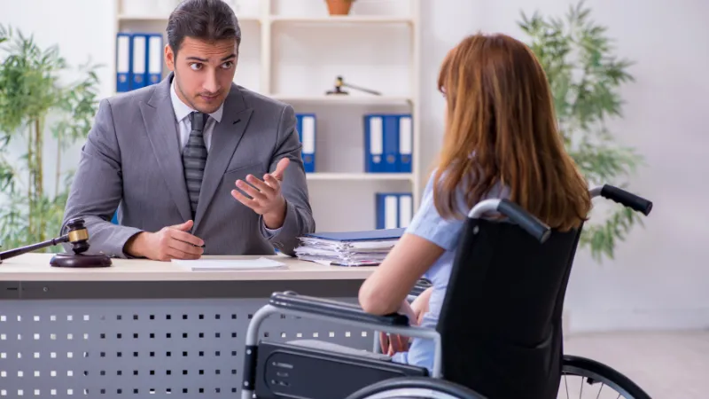 Young injured woman and male lawyer in the courtroom