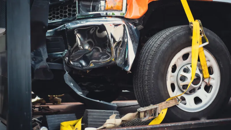 A damaged truck with its front part completely wrecked.