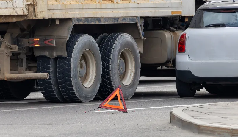 Road accident between a truck and a car on a city street