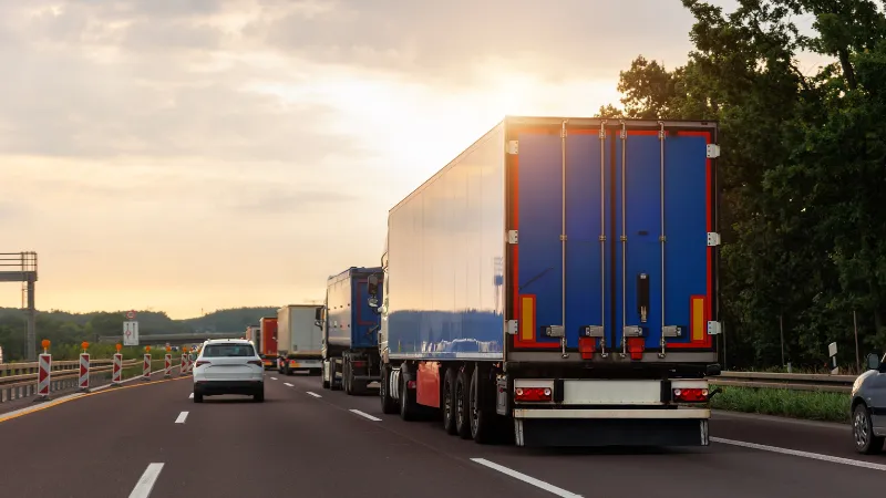 A few trucks lined up on the other lane of the road