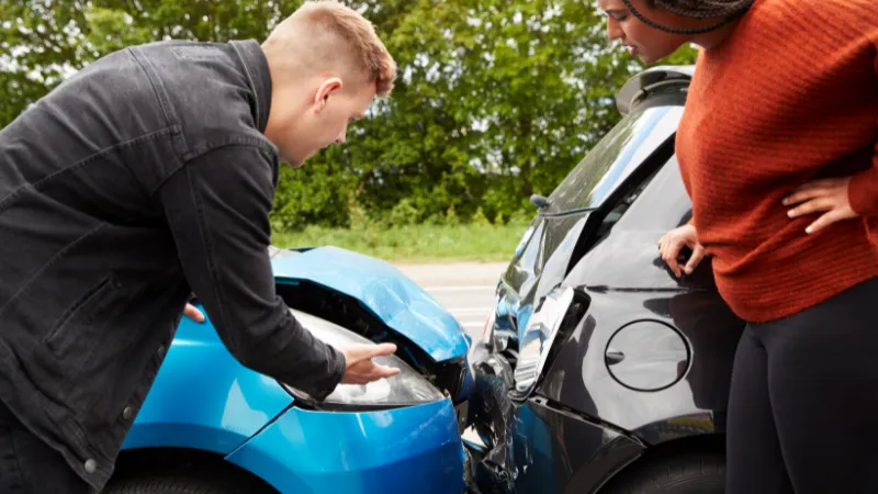 Two Angry Motorists Arguing Over Responsibility For Car Accident