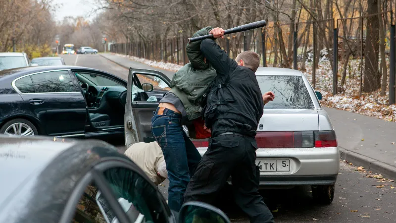 Men fight after a car accident on the road
