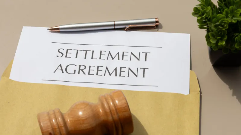 Civil Resolution: Settlement Agreement Document and Gavel Arrangement