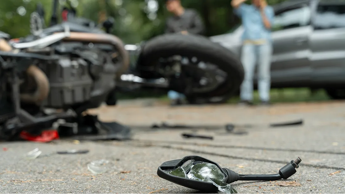 A blurry background showing a motorcycle accident.